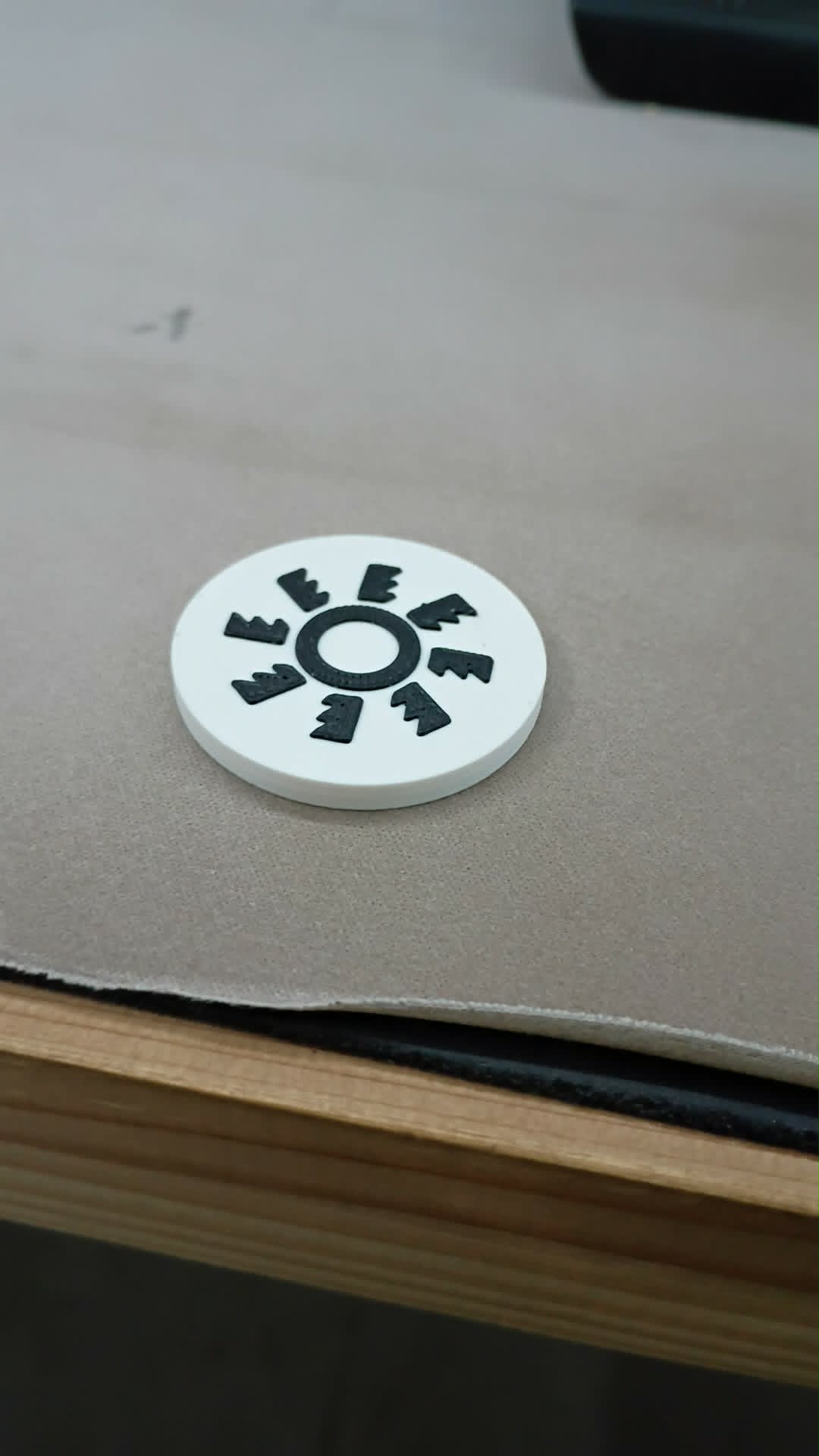 Custom 3D printed NFC prototype chip resting on a table
